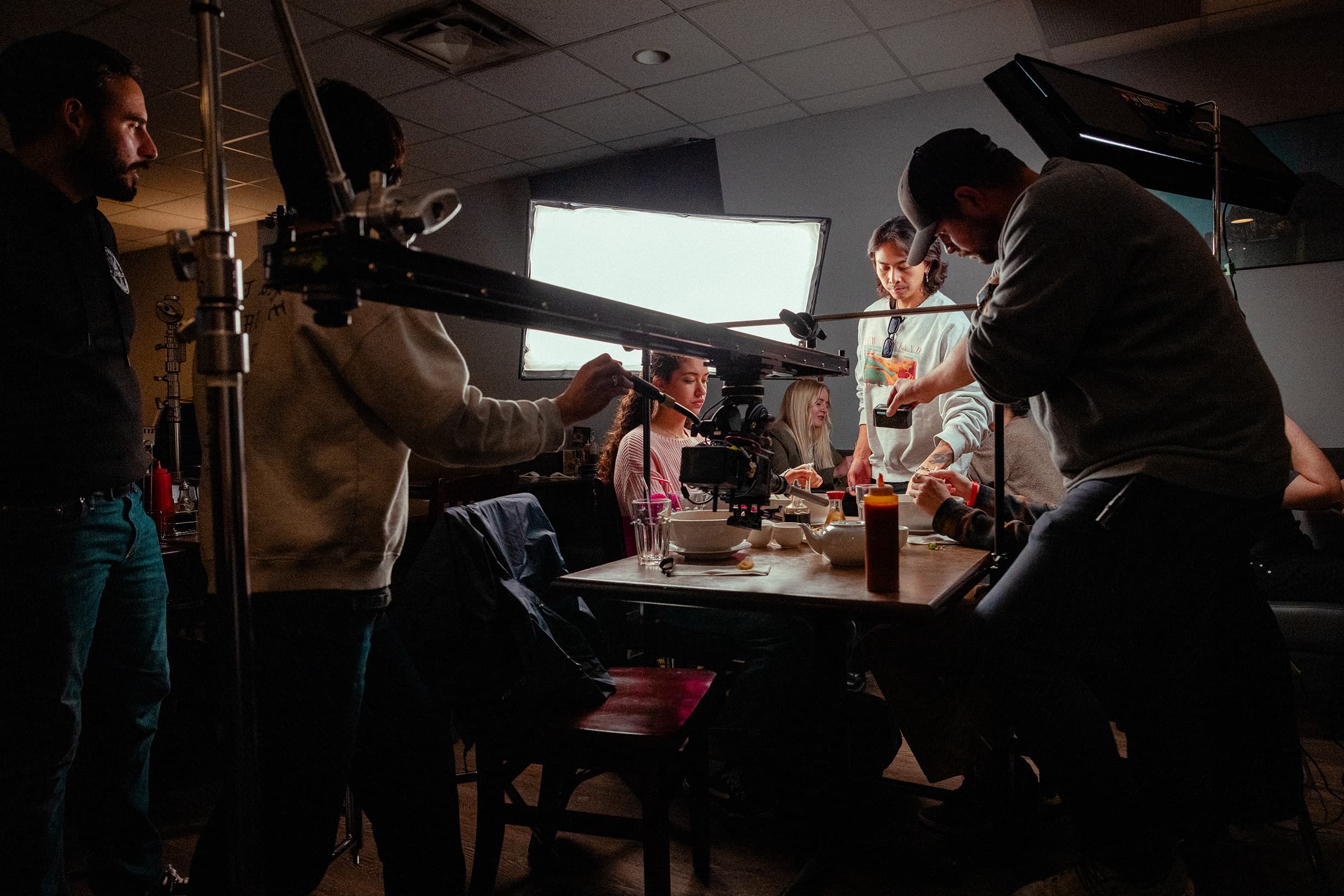 Crew around the camera on the restaurant scene